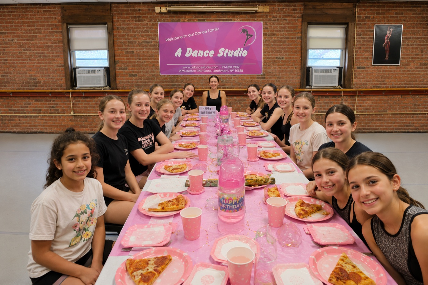 A birthday party at the pink party table in the studio