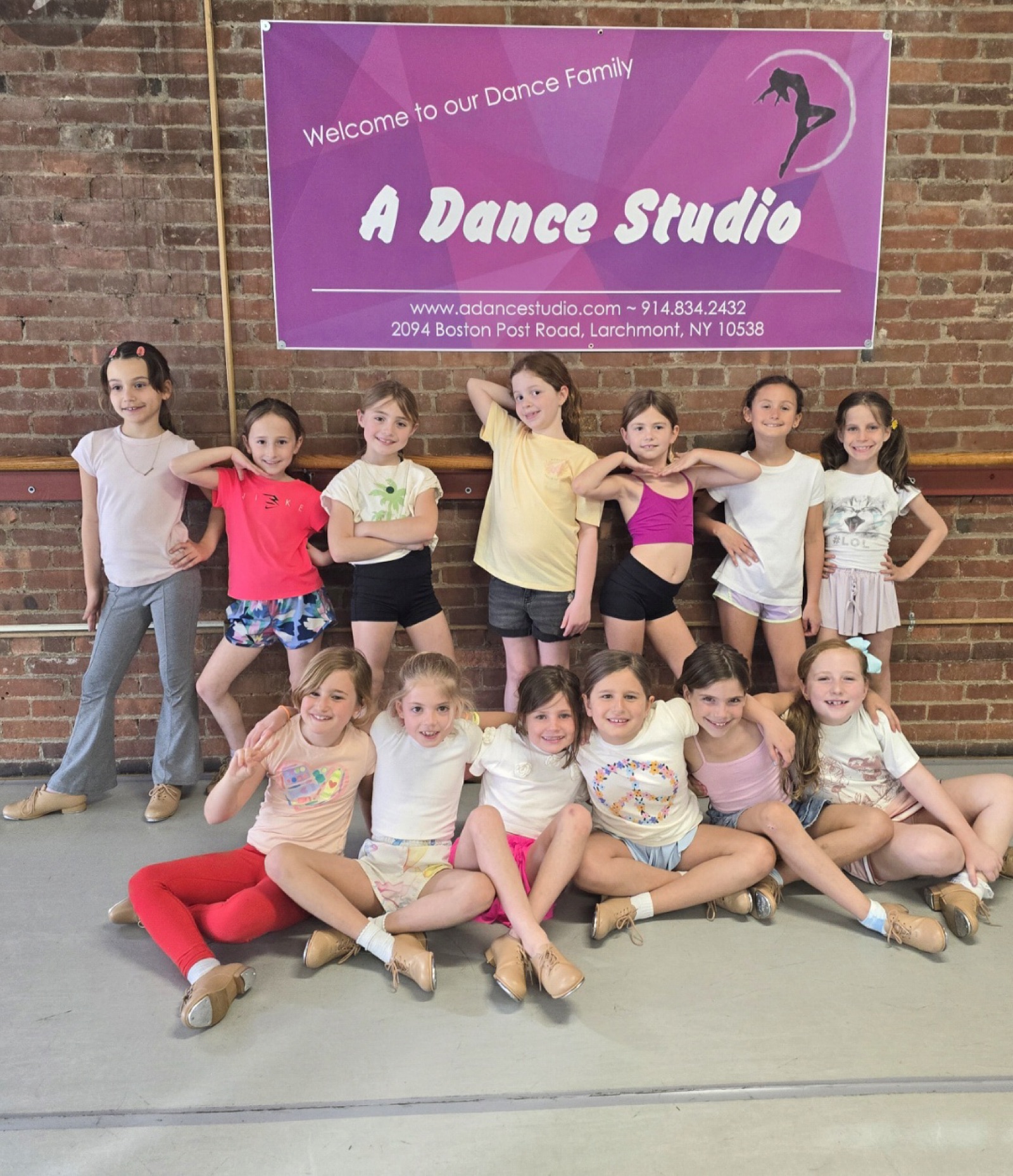 Dancers in front of the studio banner